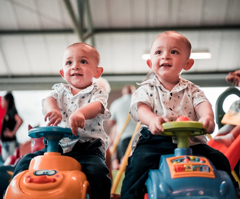 Idal and Iden, two brilliant boys' names beginning with I, are great names for these twins sitting on toy cars.