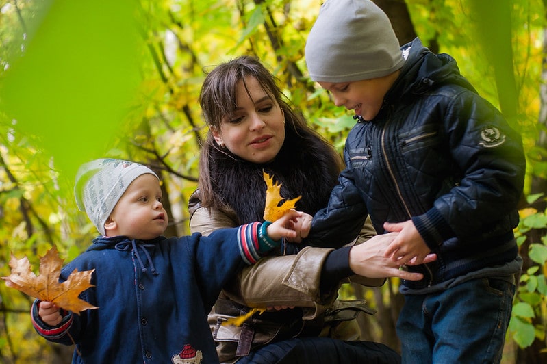 Mum and her boys who have boys' names beginning with F, enjoying nature outside
