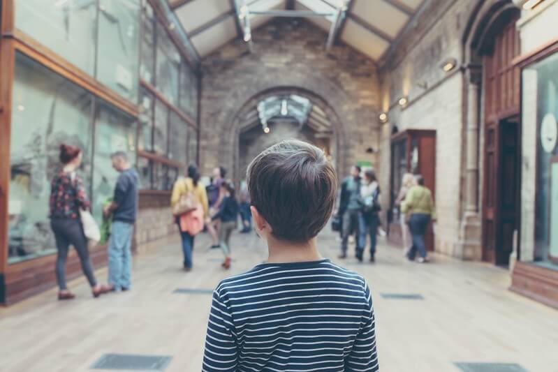 Bugspotting at the Natural History Museum, like this boy looking through a museum, is one of our fantastic minibeasts activities.
