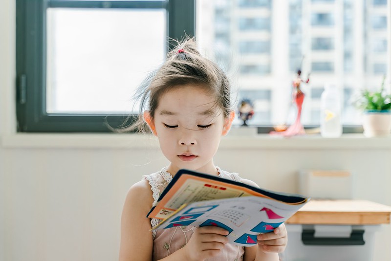 Girl reading about parenthesis use