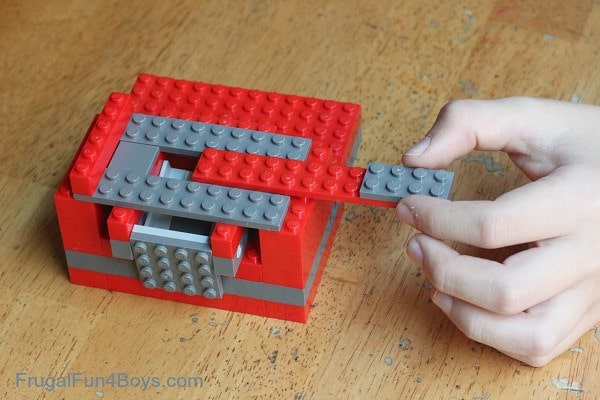 Slot a 2x10 piece attached to a 2x4 piece into your awesome lego candy dispenserd
