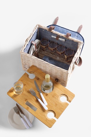 overhead shot of an open picnic basket with wooden tray