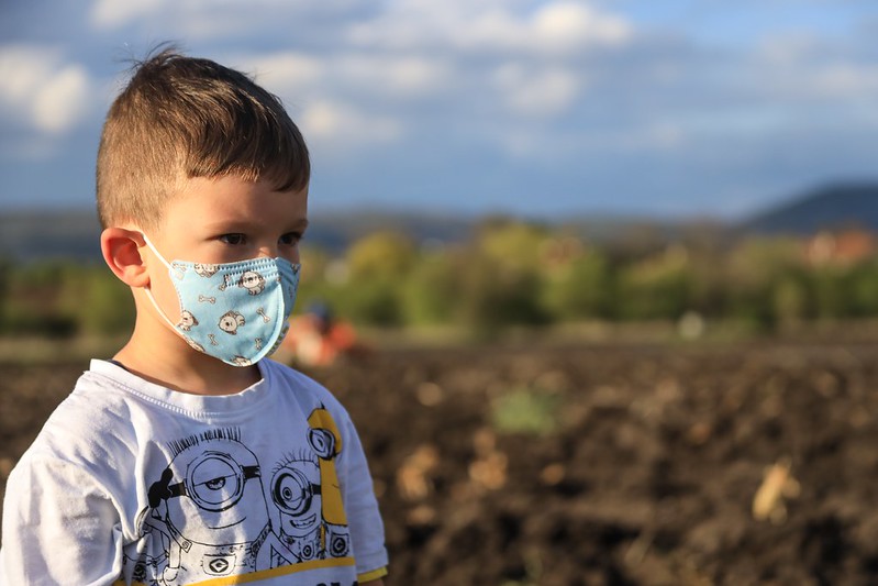 Little boy outside wearing a mask this summer