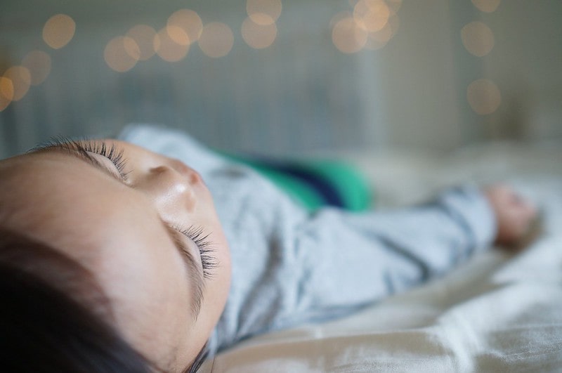 Little boy sleeping soundly in bed waiting for the tooth fairy.