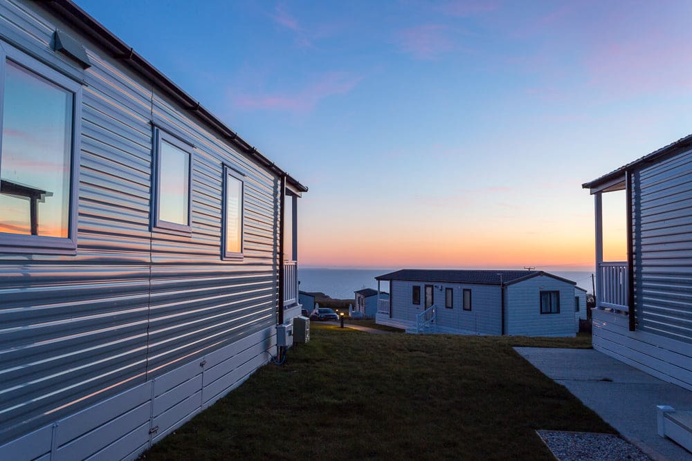 View of the sea at sunset from Sandymouth Holiday Park in Cornwall.