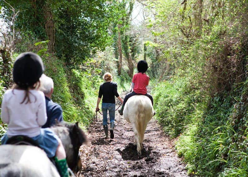 Kids going horse-riding during stay at Bosinver in Cornwall.