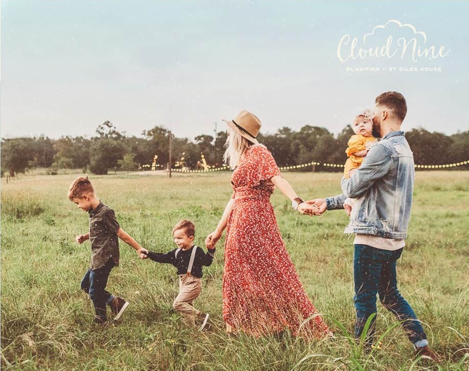 Family walking through the fields at Cloud Nine Glamping, Dorset.