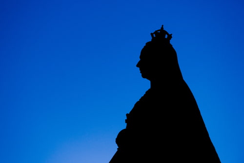 Silhouette of Queen Victoria against a blue background.