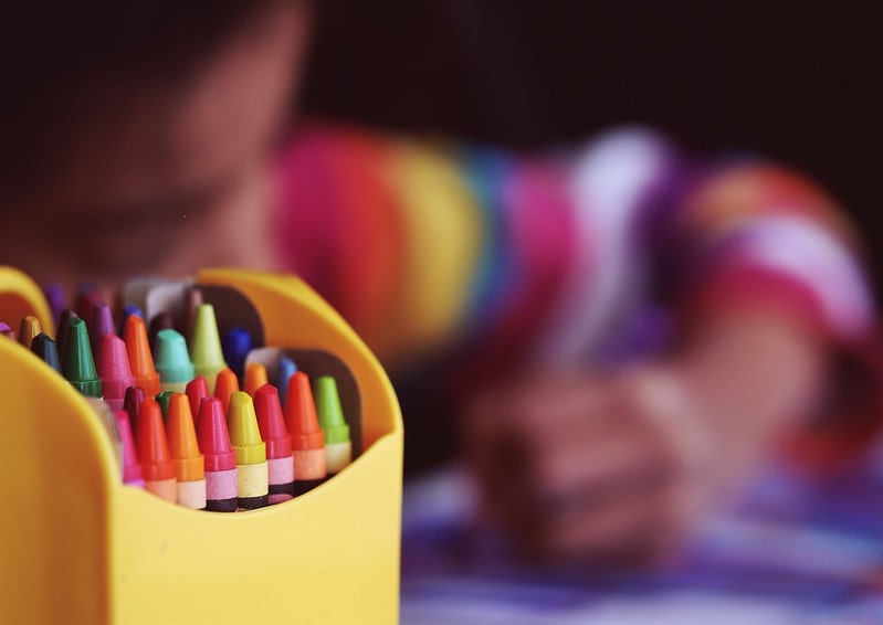 Crafts and Crayons With Girl in Background