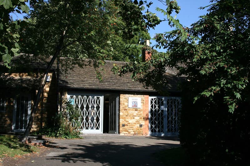 Entrance to The Blitz Tea Rooms, Kettering, with trees surrounding.