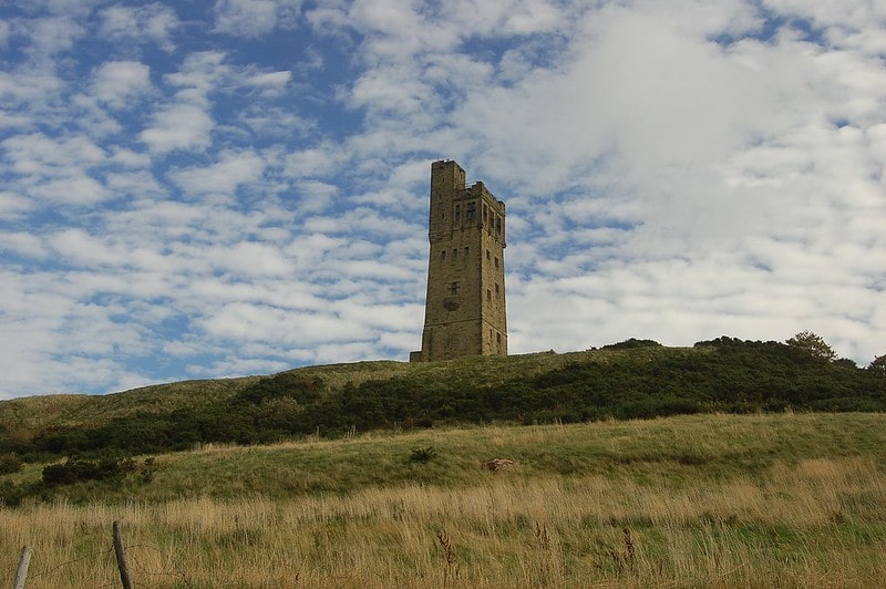 Old castle tower at the top of a hill.