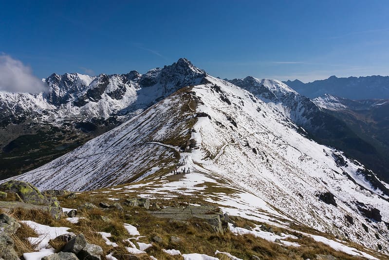 View from the summit of a snowy mountain range