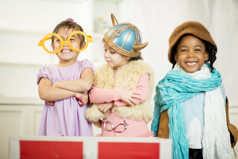 Three Kids Laughing in Anglo Saxon Costumes.