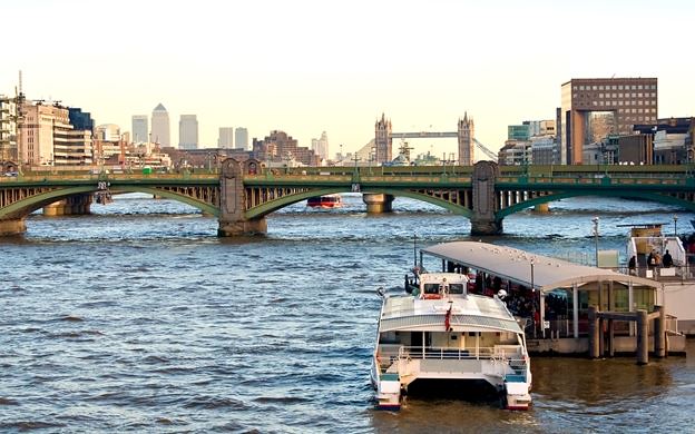 Tower Bridge and Canary Wharf seen in the distance from a City Cruises boat.