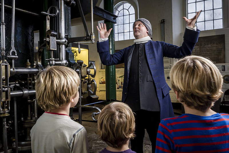 Kids at the London Museum of Water and Steam looking interested at a man