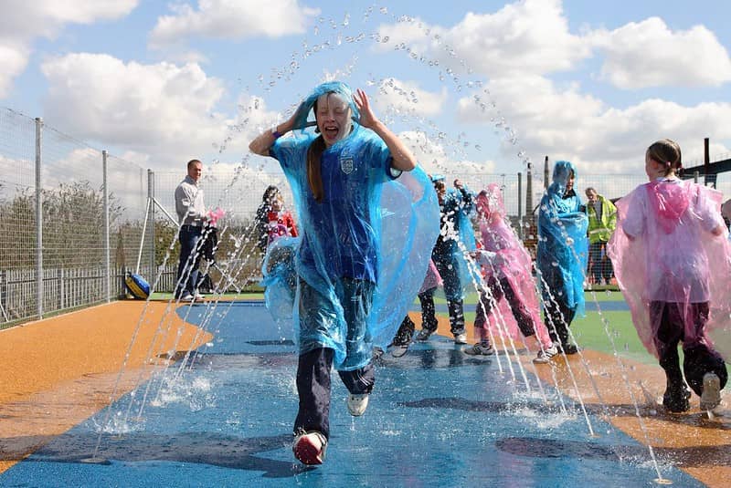 Kids enjoying AQUA-TEK running through the water.
