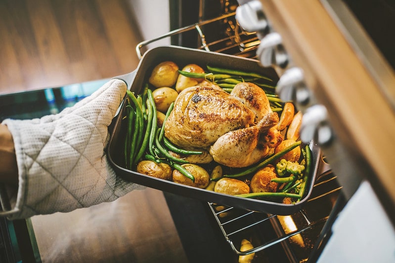 Roast chicken coming out the oven.