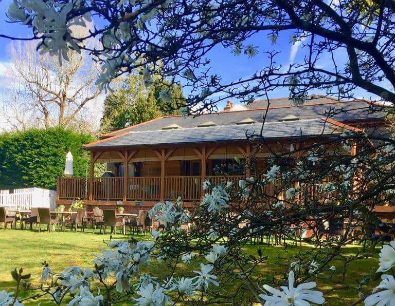 Spot in the Woods hotel with outdoor seating area and beautiful scenery.
