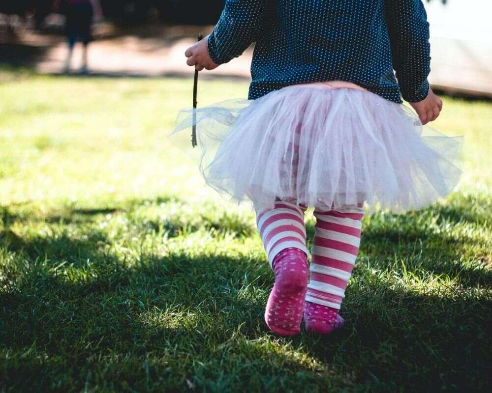 Little girl playing simon says