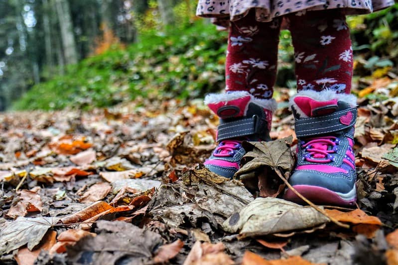 A little girl's boots while on a walk in the woods.