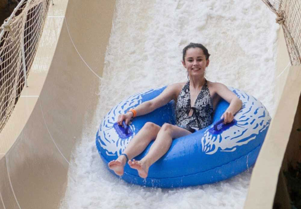 Girl riding Masterblaster ride at Sandcastle Waterpark.