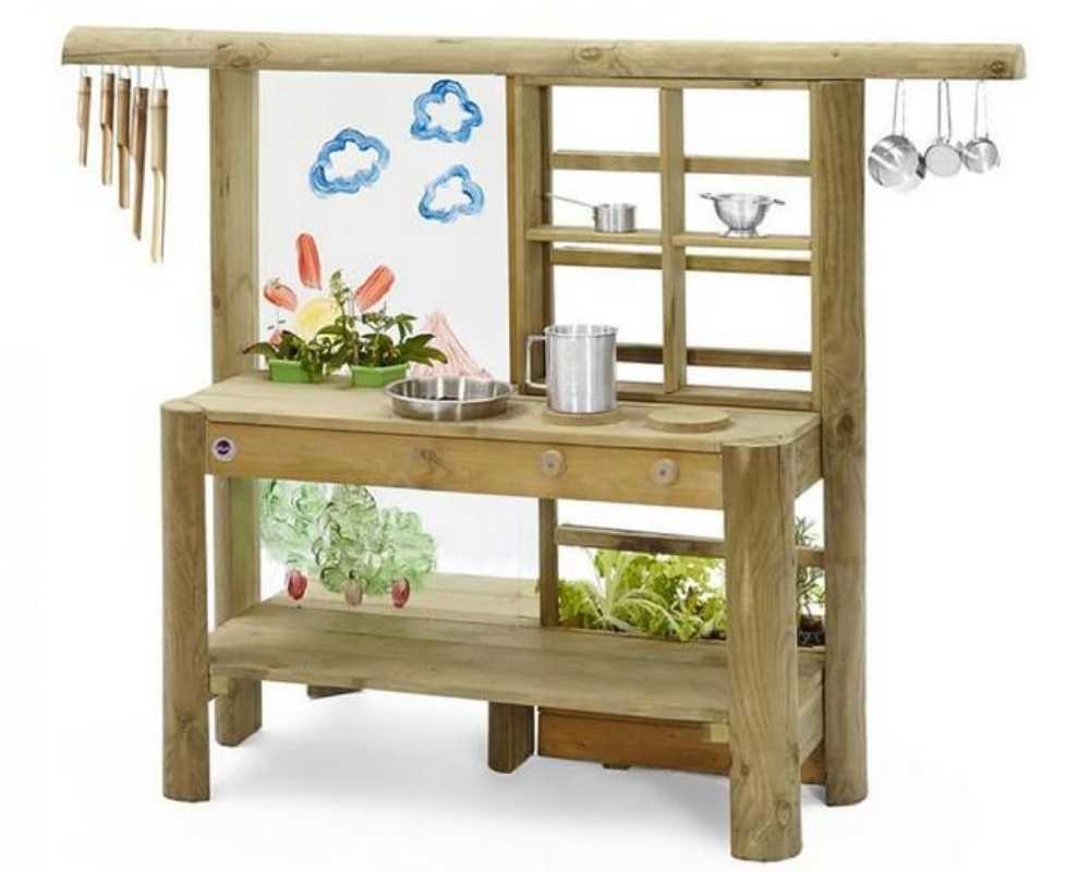 A Plum Discovery Mud Pie Kitchen with mini growing planter, sink, easy clean painting board, colour paintbrush pens, bamboo wind chimes and 3 pots.