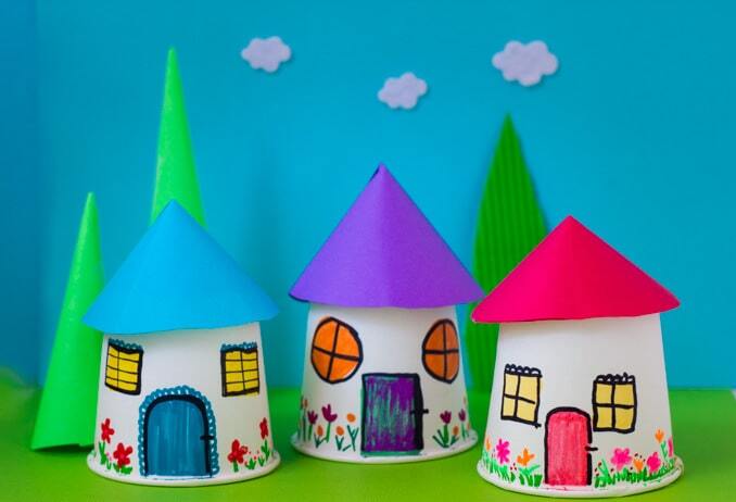 Three handmade Rapunzel towers standing in front of a blue sky background.