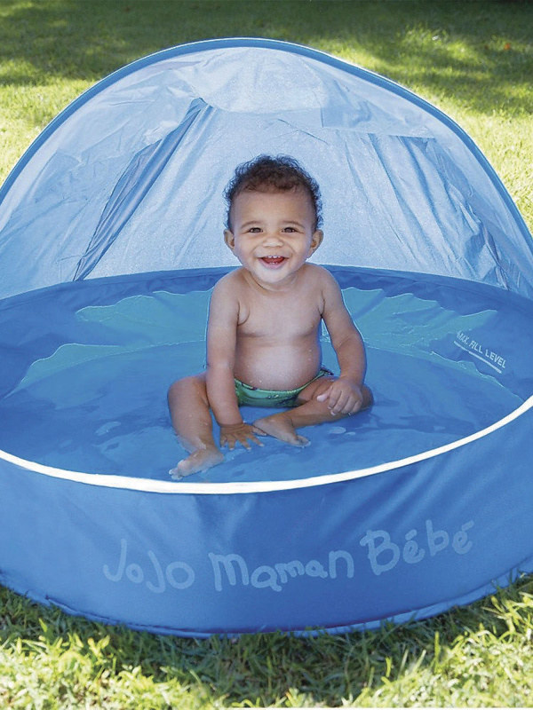 Baby laughing in a Baby Pop Up Pool.