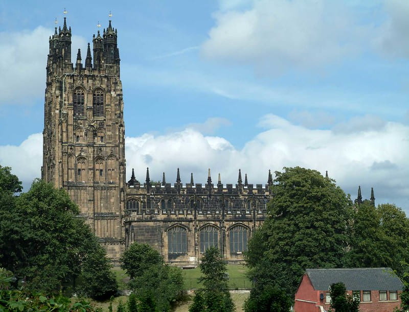 St Giles church in Wrexham, the church tower standing tall compared to the surrounding houses.