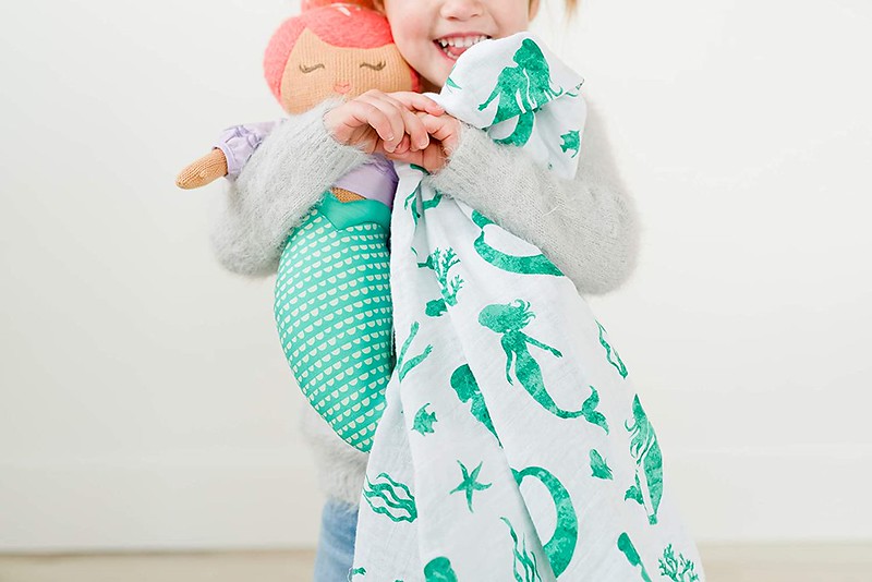An Addison Belle Mermaid Muslin Swaddle Blanket.
