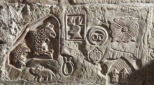The engraved walls at Carlisle Castle, Cumbria, with intricate details carved into them.