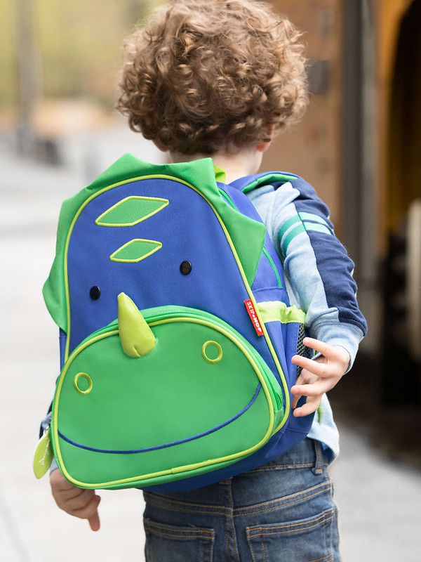Child wearing the Skip Hop Zoo Pack Dragon Bag.