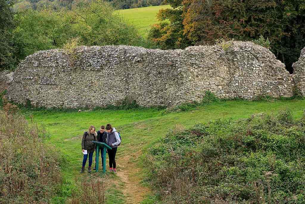Group of three friends reading a sign on a walk at White Horse Wood Country Park.