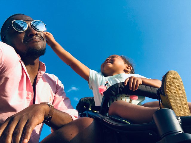 Little girl is playfully pinching her dad's face on a family day out in Maidstone.