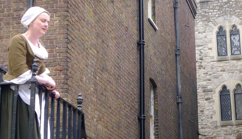 A Victorian lady looking on at a public punishment from her balcony.