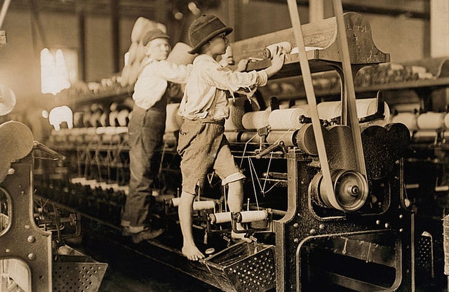 Two young boys working in the weaving factory.