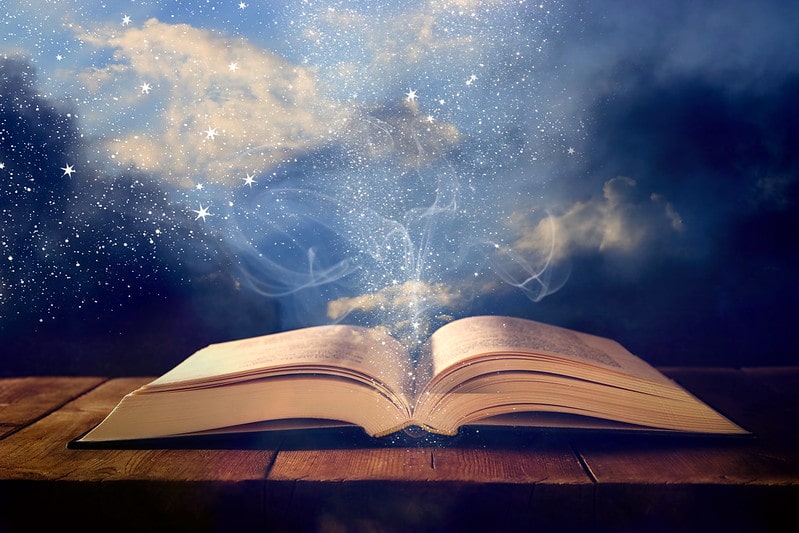 An open antique book with magic dust and mist coming out the pages.