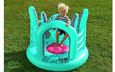 Child playing in turquoise octopus bouncy castle.