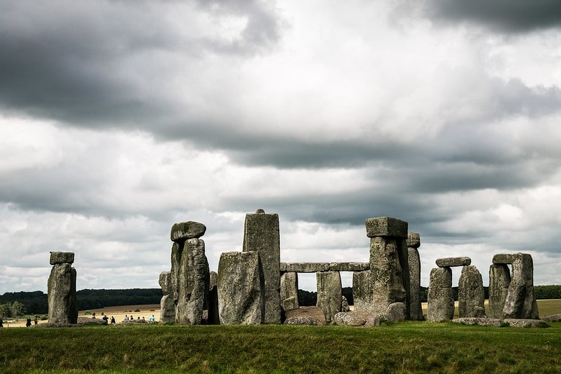 Stonehenge on a cloudy day with grey clouds above.