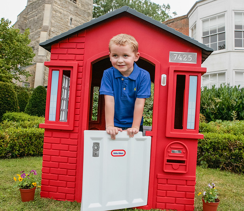 Child in Little Tikes Cape Cottage Playhouse.