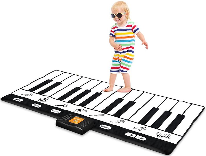 Child playing on NEWELL Playmat Keyboard.