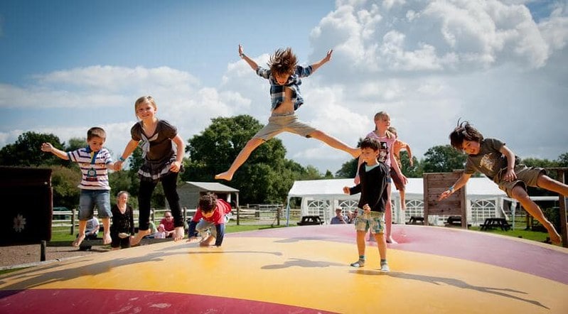 Kids jumping and playing at Fishers Farm Park.