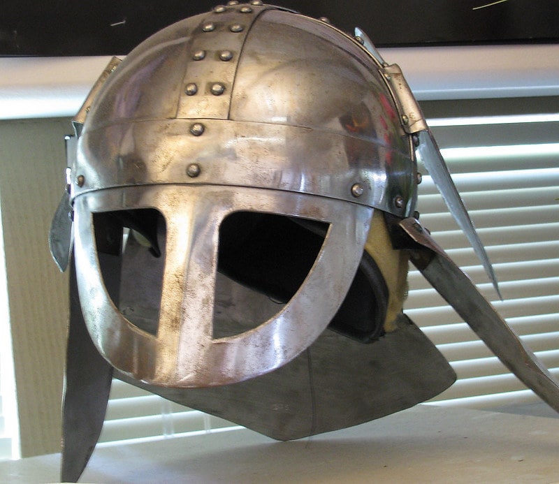 Viking mask helmet made out of silver metal.