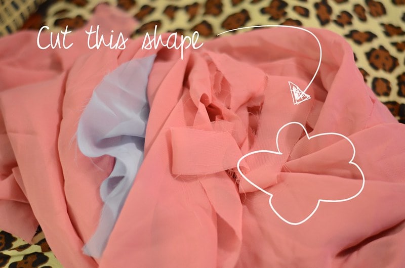 Outline of a flower drawn onto a photo of material, which can be used as a template for a brooch.