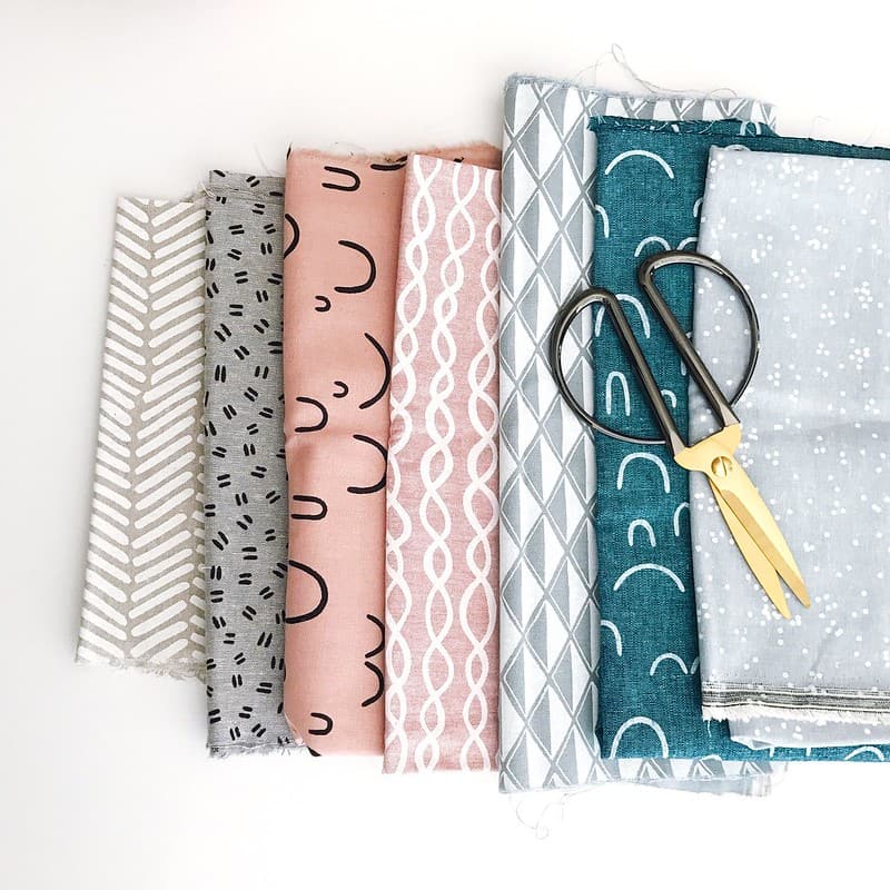 Different patterned fabrics laid out on op of each other.