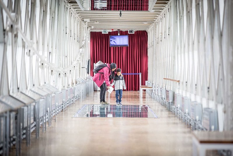A mother with her child exploring the glass walkways at Tower Bridge.