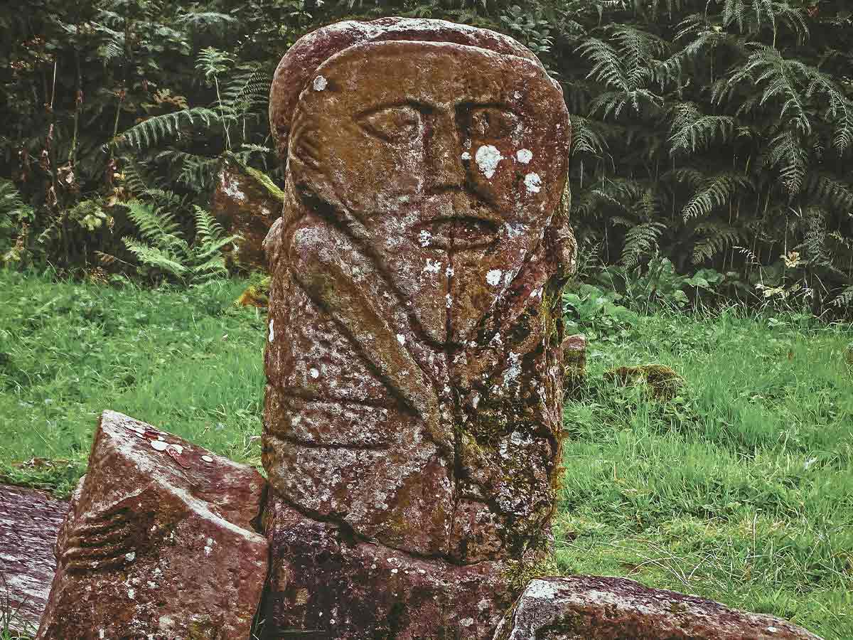 Celtic stone, resembling a tombstone, with a face engraved into it.