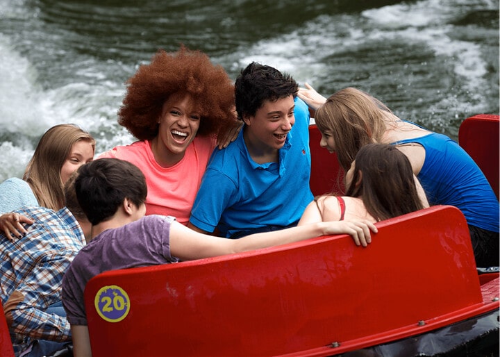 Friends and family enjoying the slopes in Rumba Rapids water ride.