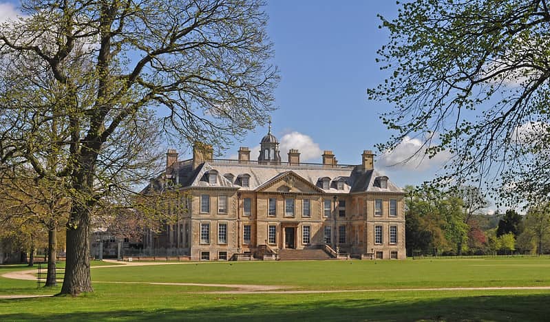 View of the historic Belton House and lawns on a bright, sunny day.
