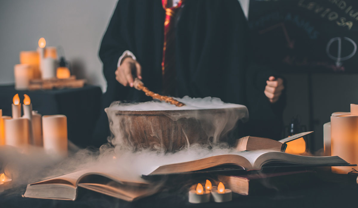 Young wizard at Hogwarts making a potion.